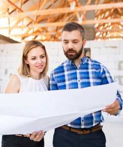 young-couple-at-the-construction-site-P9SQKFW.jpg